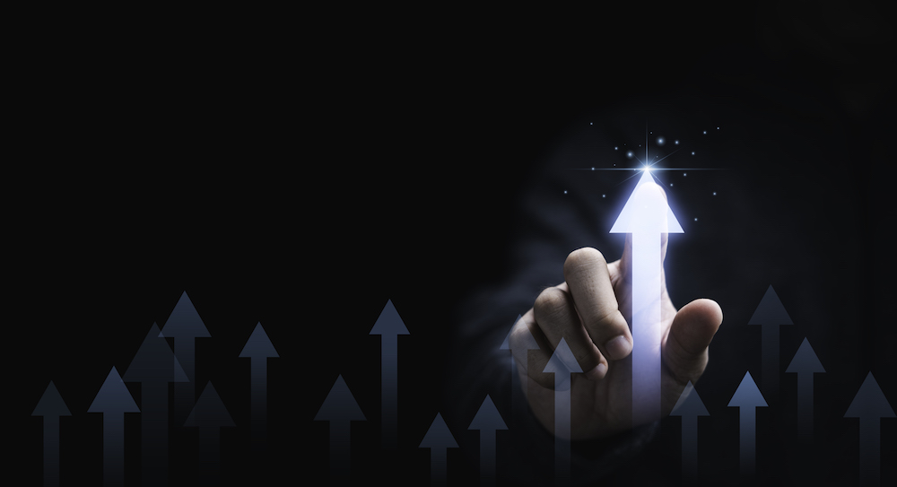 Businessman hand pointing to increasing arrow with percentage for business profit development growth to success concept.